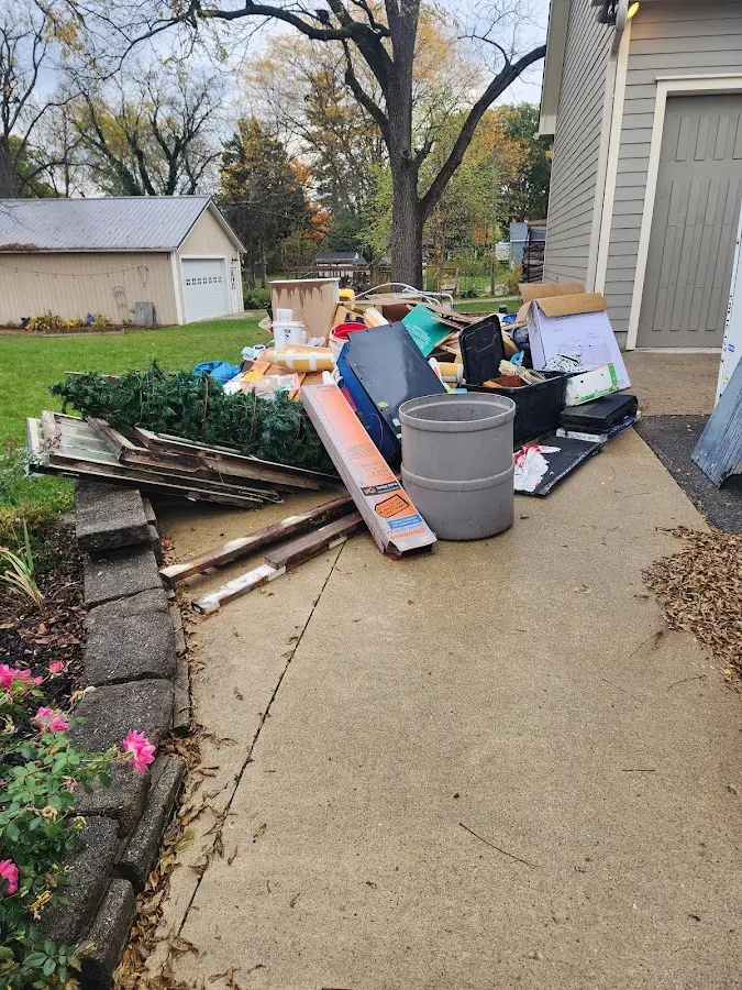 Dumpster being loaded with debris for Commercial Dumpster Rental in Hartselle